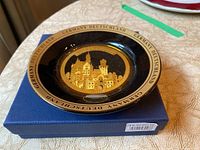 Close-up photo of German collector plate showing gold castle design and text on rim