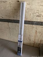 Full view of boxed Mainstays cordless window shade in white, vertical position.