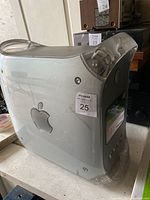Side angle view of Apple Power Mac G4 desktop computer showing translucent white casing with Apple logo, front CD/DVD drive and buttons.