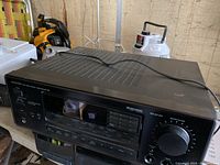 Front and top angled view of Onkyo Audio Video Control Tuner Amplifier R1 showing controls, master volume knob, and ventilation on top