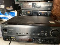 Front and top view of the Pioneer VSX-604S Audio/Video Stereo Receiver showing the full front panel and some wear on top.