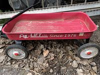 Photo of red All-Lift Ltd. wagon showing side branding 'Since 1976' with visible dirt and signs of wear