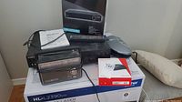 Full lot showing Sony VCR, Curtis DVD player box, General Electric radio clock, computer mouse, and instruction manuals.