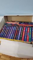 Box filled with Star Trek novels showing spine titles and different colors.