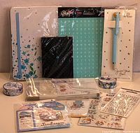 Photo showing the full lot of journaling supplies including notebooks, stickers, washi tapes, and pen still in packaging.