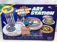 Box of Crayola Spin and Spiral Art Station with images of included markers, paints, brushes, spiral and spin art samples on the front.