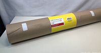 Full view of the new kraft wrapping paper roll with label showing dimensions and description.
