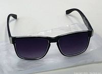 Front view of black sunglasses with rectangular gradient dark lenses