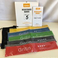 Set of five Gritin resistance bands in different colors with their box, user guide, and carrying pouch