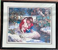 Full view of the framed print showing a child in a red jacket hugging a white dog by a snowy creek.
