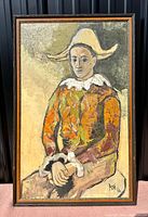 Full view of original oil on board painting of a harlequin figure wearing colorful costume and distinctive hat, framed.
