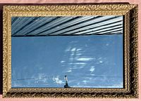 Front view of the rectangular mirror showing the ornate gold tone frame and clear reflective surface.