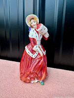 Front side view of the Royal Doulton Christmas Morn figurine showing detailed face, dress, muff, and bonnet.