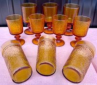 Amber textured glassware set including 8 stemmed goblets and 3 matching textured tumblers in amber color with Mid-Century Modern style.