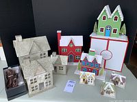Full set of 10 houses including glittery gold houses, painted houses, and small glitter roof ornaments shown with power cords and boxes