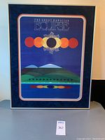 Full view of the framed eclipse print showing the artwork and the frame.