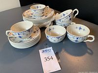Set of six dessert plates, six cups, and six saucers arranged on table