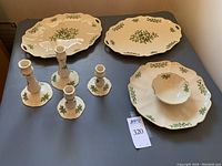 Full set showing two pairs of Lenox candlesticks, one tall pair (7 inches) and one short pair (4.5 inches), a vegetable dip platter with central bowl, and two large platters in Holiday pattern