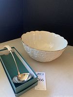 Photo showing the cream-colored punch bowl and stainless steel ladle in original box