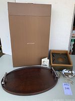 Photo showing entire lot including wood tray, silver nut dish, packaging box marked 'ATTICUS', and an informational card.
