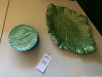Overview photo showing the large leaf-shaped serving platter and the six smaller matching small plates stacked beside it.