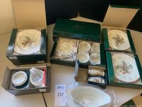 Photo of the Queensbury Royal Gallery fine china items in original boxes showing plates, cups, saucers, salt and pepper shakers wrapped in packaging.