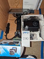 Opened black zippered carrying case containing the Magellan GPS device, USB cable, and quick start guides