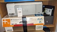 HP Photosmart C4150 printer in original packaging with a JPMP auction tag on the printer.