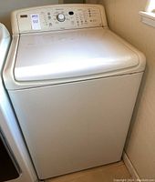 Front view of the washer with lid closed showing overall condition and design
