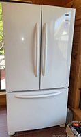 Front view of closed French door refrigerator and freezer drawer