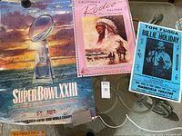 Three posters arranged flat showing full designs