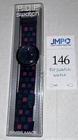 Full view of POP Swatch watch in original plastic packaging showing the strap and watch face.