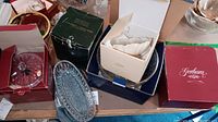 Photo shows multiple boxed and unboxed crystal dishes including a covered candy dish, Lenox bowl, and a clear crystal oval dish.