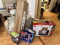 Overview of all items including boxes with Ronco Ready Grill and other household items