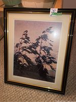 Framed print showing stylized trees with textured pastel background, focus on entire artwork and frame.