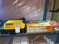 Photo of DeWalt crown stops in yellow box and another tool box on shelf