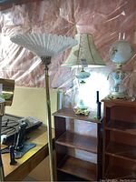 Overview photo showing both lamps and a wooden shelf background in a basement setting