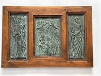 Full view of the framed antique embossed metal relief art depicting Mary, Jesus, and angels in three panels.