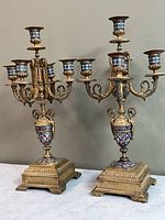 Front view of both candelabras showing five candle cups and cloisonné panels