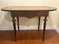 Full front view of table with drop leaves extended showing overall structure and condition