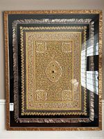 Full front view of framed wall rug showing black velvet border, silk fringe, sculpted wooden frame and embroidery