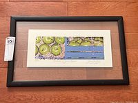 Framed full view of the art print showing green apples in a crate labeled with tag.