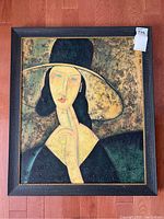 Full view of framed reproduction oil painting showing an abstract portrait of a woman wearing a large hat with textured canvas and earth-tone colors.