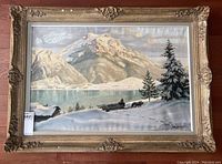 Full view of framed oil painting showing winter mountain scene