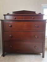 Front view showing overall dresser, raised backsplash and knob pulls