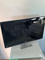 Front view of HP 2509b monitor showing screen and stand.