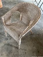 Side angle showing the structure, woven wicker detail and condition of the IKEA wicker chair.
