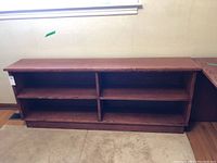 Front view of the oak veneer bookcase showing open shelving compartments and overall structure.