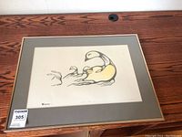 Framed First Nations style print showing stylized geese in black and yellow on cream background with signature and numbering visible.