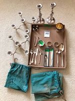 Overview of all items including candlesticks with add-ons, shakers, flatware, ramekin, cup